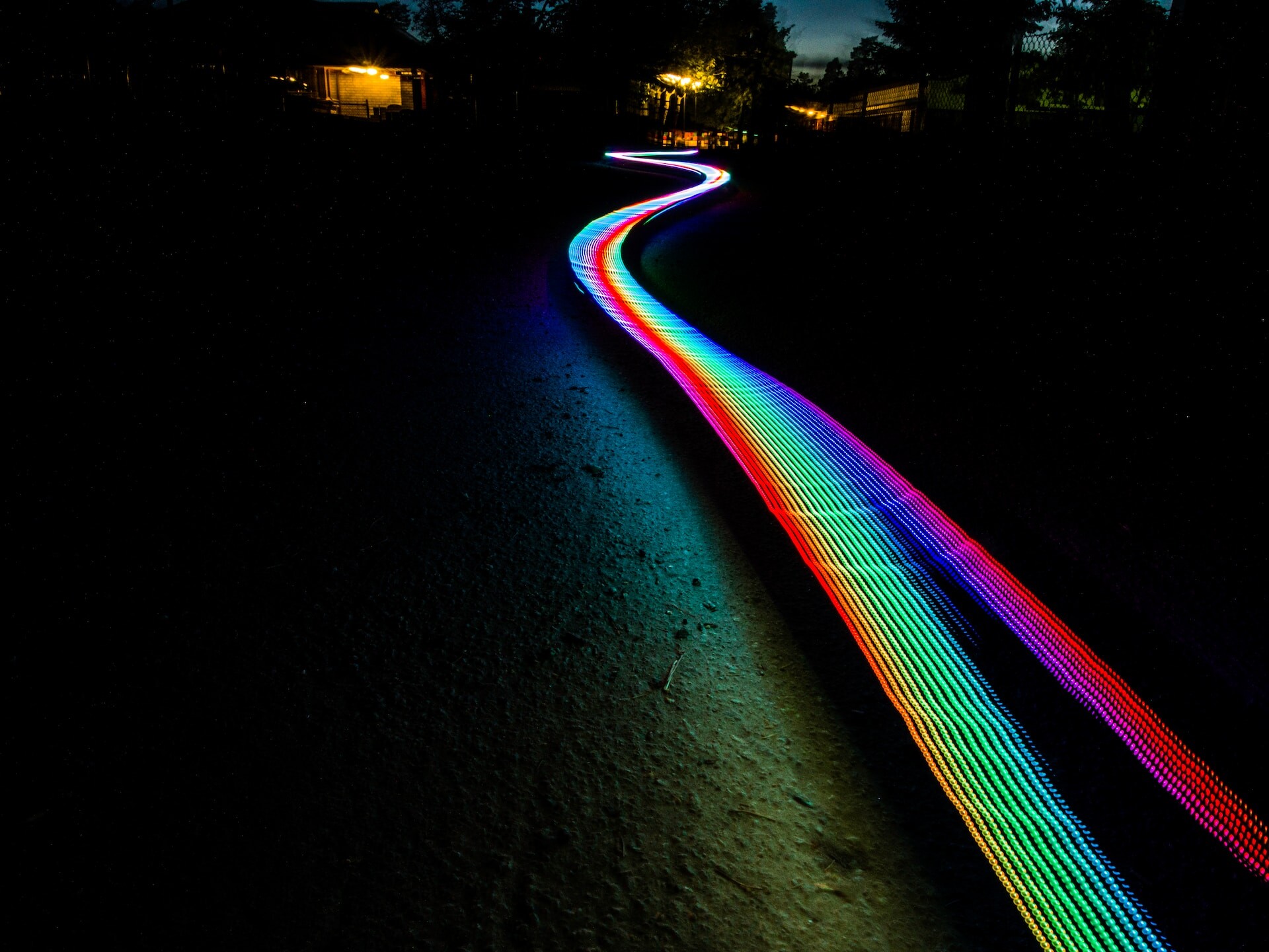 Rainbow smudge going through a dark rural place